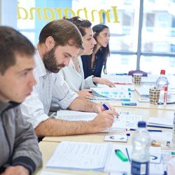 Classroom course attendees in the Imparando Learning Centre taking notes - Thumbnail