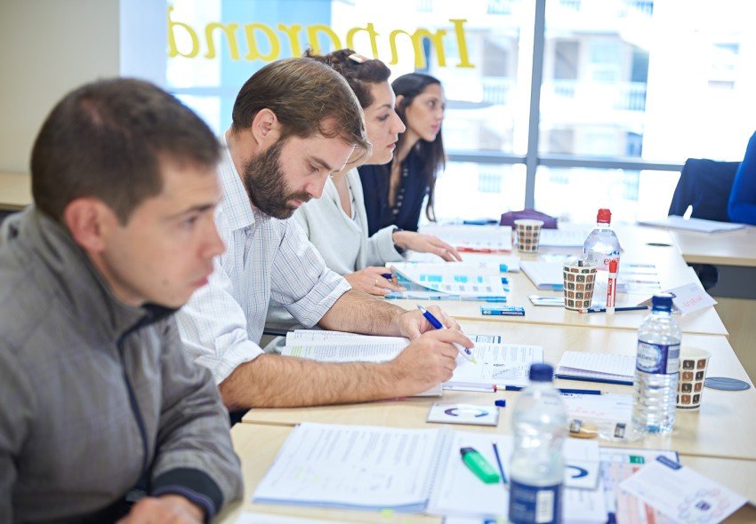 Classroom course attendees in the Imparando Learning Centre taking notes