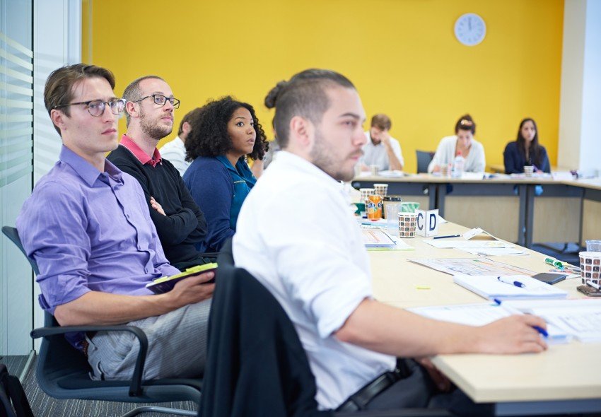 A class of project management delegates looking attentive